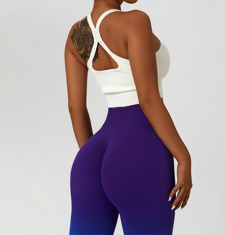 Back view of woman in purple gradient seamless high waist yoga leggings and white top
